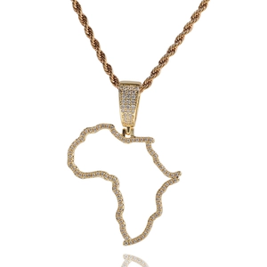 Detailed close-up of iced out gold Africa map pendant with micro paved zircon stones