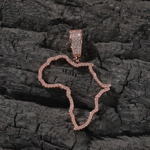 Macro shot of rose gold Africa map pendant with cubic zirconia on charcoal