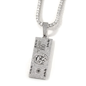 Macro detail of iced-out 100 dollar bill pendant with zircon on tennis chain