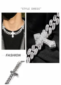 Macro detail of silver iced out Cuban link chain with a cross pendant for men