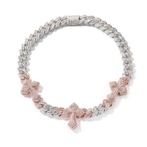 Detail of hip-hop cuban chain with iced-out cross pendants in silver and rose gold