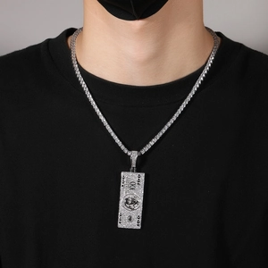 Macro detail of iced out dollar sign pendant on tennis chain for hip hop street fashion style