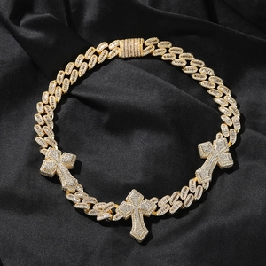 Close-up of hiphop Cuban link necklace with iced out crosses on black silk background