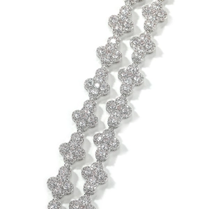 Detailed macro view of silver clover long necklace with pave-set shimmering crystals