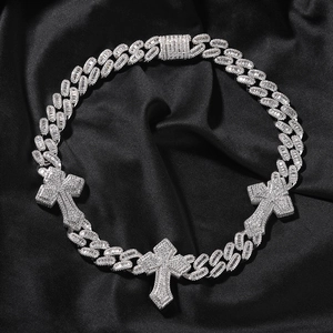 Detailed top view of hip-hop iced out Cuban link chain with three diamond cross pendants