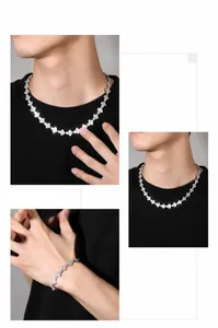 Close-up of hip hop silver clover necklace and bracelet set with sparkling diamonds