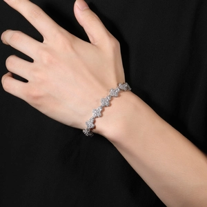 Close-up of silver-toned hip-hop clover chain with shimmering pave-set zircon stones
