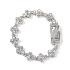 Detail of silver clover bracelet with inlaid white zircons and encrusted jewelry clasp