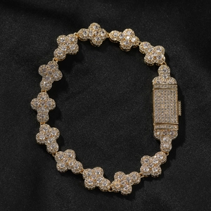 Detail of clover link bracelet in gold finish with micro-set cubic zirconia on black silk