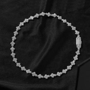 Detailed macro view of silver clover links encrusted with sparkling cubic zirconia