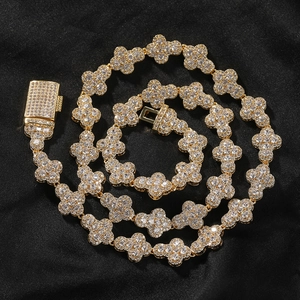 Macro detail of gold hip-hop necklace featuring micro-pasted zircon clover links