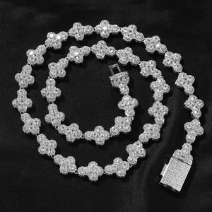 Macro shot of silver hip hop necklace with clover links and sparkling pavé-set stones
