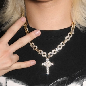 Close-up of hip hop gold cross pendant necklace with zircon chain on male model