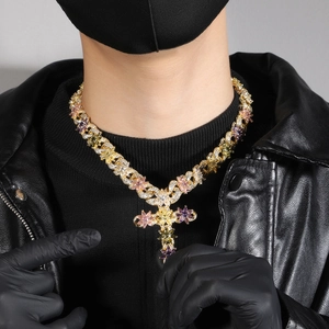 Detailed view of hip hop cross necklace with colorful zircon flowers on a male model