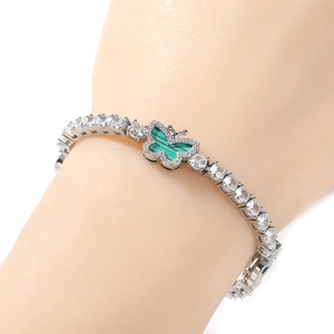 Detail of silver tennis chain bracelet with a green malachite butterfly pendant