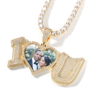 Detailed view of custom gold heart locket with I heart U design and tennis chain