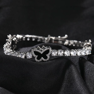 Silver-tone tennis bracelet featuring a central black butterfly charm and clear zircons