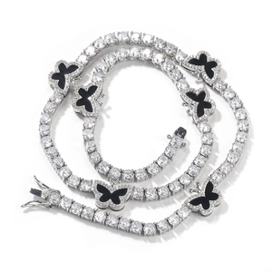 Detail of silver tennis chain featuring sparkling zircons and black butterfly pendants