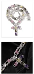 Macro shot of silver cross pendant with colorful zircon flowers on black silk
