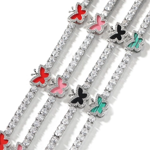 Detail of tennis bracelets with colorful butterfly pendants and sparkling cubic zirconia