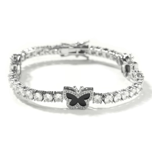 Detail of silver tennis chain featuring round zircons and black enamel butterfly charm