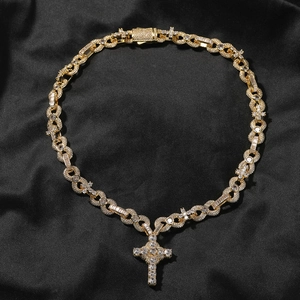Close-up of hip-hop cross necklace with gold plating and pavé set cubic zirconia