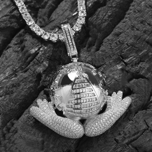 Macro shot of silver hip-hop earth pendant with 5A zircons and pyramid engraving