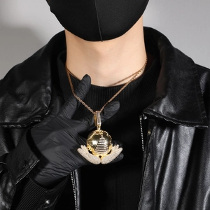 Hip hop gold necklace featuring a globe and pyramid pendant held by iced-out hands