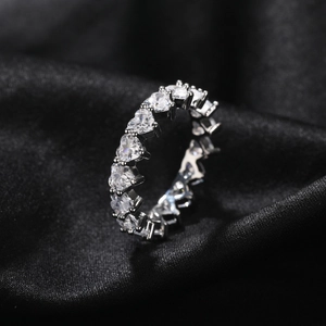Détail de pierres de zircone en forme de cœur sur un anneau d'éternité en argent