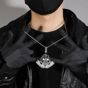 Detailed view of silver globe pendant with pyramid design and micro-pave zircons