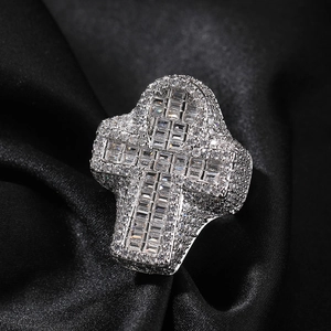Macro view of iced-out Ankh cross ring with pavé-set clear cubic zirconia on black silk