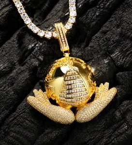 Macro shot of gold plated hip hop necklace featuring earth pyramid pendant with 5A zircons