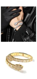 Detailed macro view of gold and silver Hamsa Hand bracelets with zircon micro-paving finish