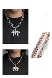 Detailed macro view showing the iced out zircon cross pendant and Cuban link chain texture