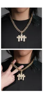 Macro shot of gold-plated iced-out triple cross pendant with sparkling cubic zirconia