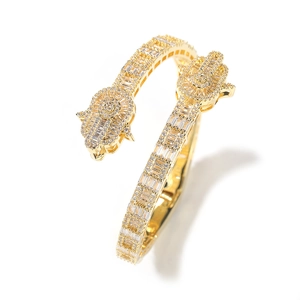 Macro shot of gold Hamsa hand bracelet with sparkling baguette and round zircon inlay