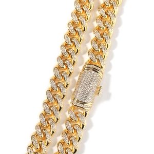 Macro detail of iced-out cuban link chain with zircon stones and gold-plated finish