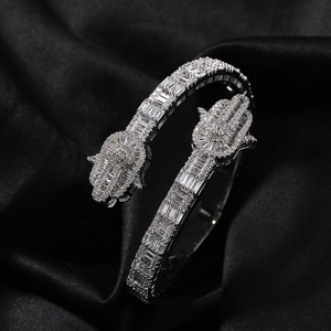 Macro shot of silver Hamsa Hand bangle featuring baguette-cut and round cubic zirconia