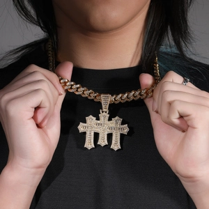 Close-up of hip-hop golden Cuban chain with triple cross pendant and paved zircons