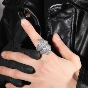 Hip-hop silver-toned dollar sign ring iced out with cubic zirconia crystals on hand