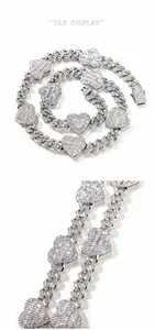 Macro detail of silver hip hop Cuban chain featuring iced-out heart links with zircon stones