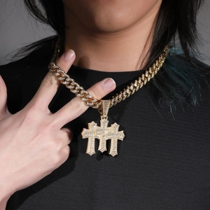 Hip hop triple cross pendant with zircon stones on gold cuban link necklace worn by model