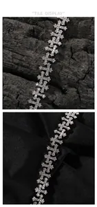 Detailed view of silver cross chain bracelet with pavé-set zircons on luxury background