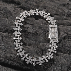 Detailed macro view of silver hip-hop bracelet with iced-out cross links and zircon stones