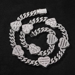 Close-up of hip hop silver Cuban chain necklace with iced out heart baguette pendants