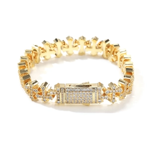 Close-up of gold hip-hop cross bracelet with sparkling cubic zirconia pavé stones
