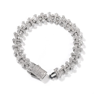 Close-up detail of iced out hip hop cross bracelet with micro pave cubic zirconia