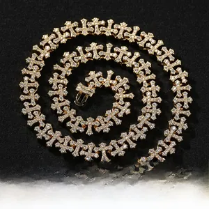 Macro detail of gold hip hop cross chain with cubic zirconia stones and square clasp