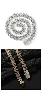 Close-up of hip hop cross link chains in gold and silver with iced out diamond details