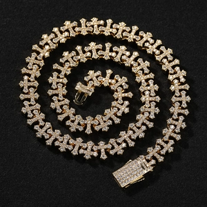 Macro view of gold-plated iced out cross link chain with paved white zircon stones